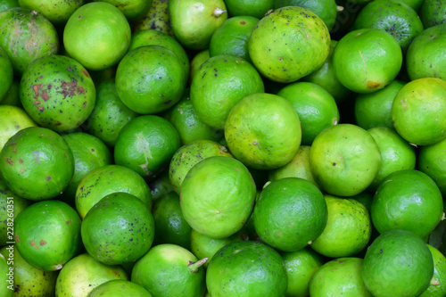 Green lemons at the market.