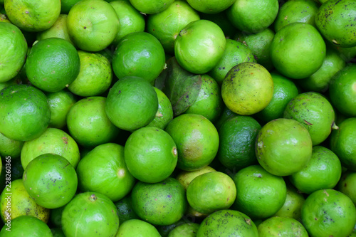 Green lemons at the market.