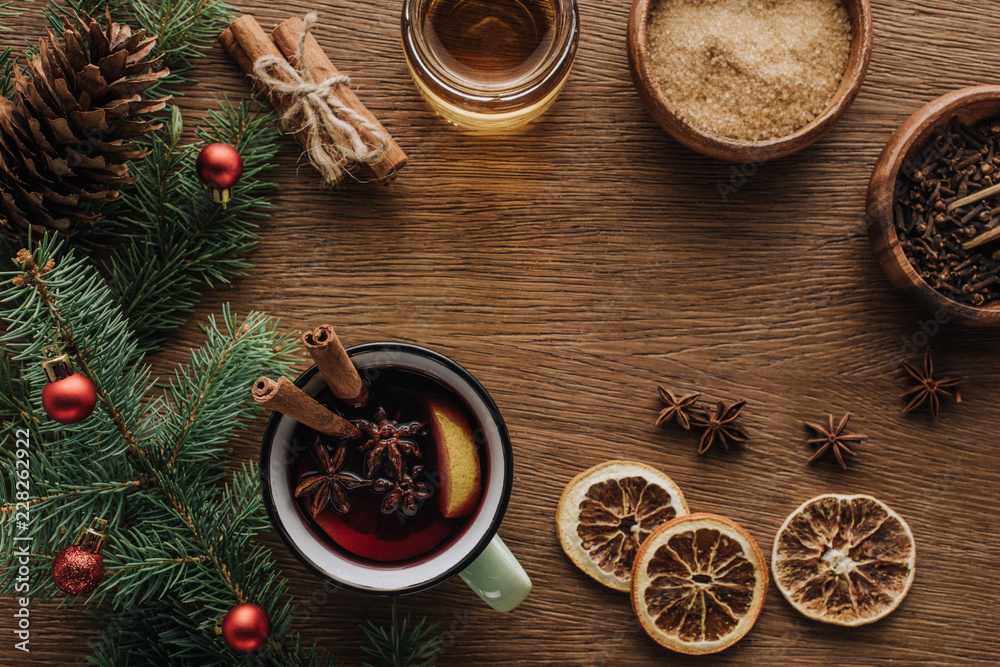 top view of spice mulled wine and fir twigs with baubles on wooden tabletop, christmas concept top view of spice mulled wine and fir twigs with baubles on wooden tabletop, christmas concept