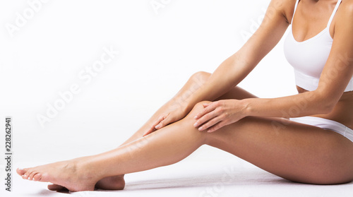 Woman touching own legs
