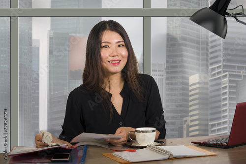 Photography young happy and beautiful Asian Korean entrepreneur woman working at modern offi