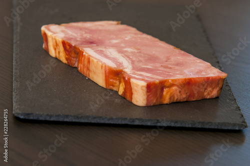 Baked ham on black slate board, close-up