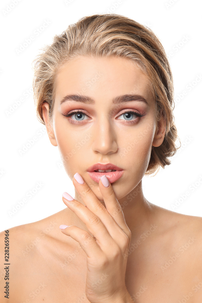 Beautiful young woman with nude makeup on white background