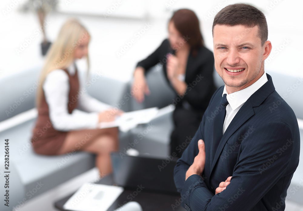 young businessman on blurred background office. young businessman on blurred background office.