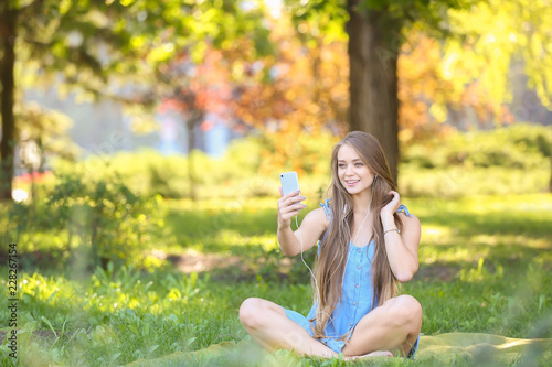 Beautiful young woman liste...