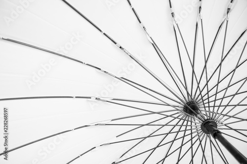 Bright black and white detail of umbrella frame. Background concept