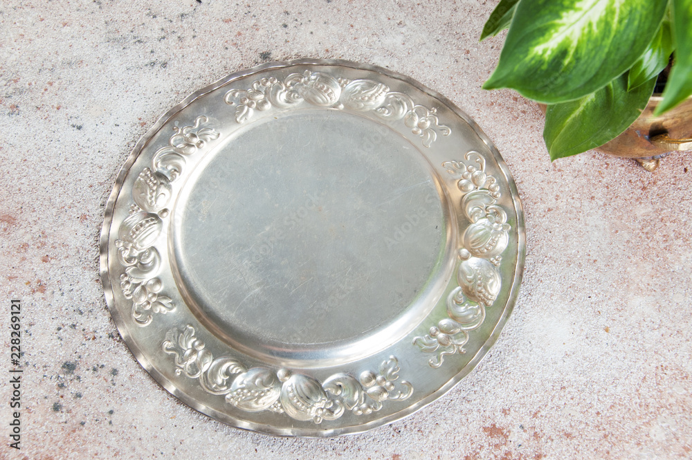Fototapeta premium Vintage silverplate dish and green plants