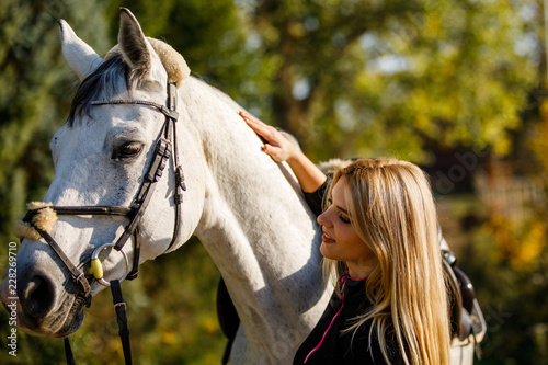 Slika na platnu Woman with horse in park