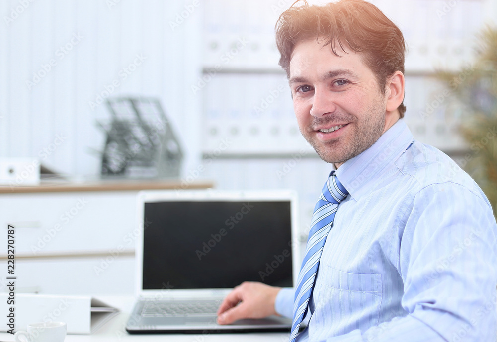 closeup.handsome businessman sitting in this Desk closeup.handsome businessman sitting in this Desk