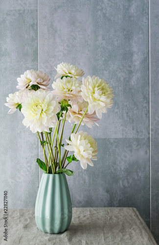 Fototapeta Naklejka Na Ścianę i Meble -  Bouquet of dahlia flowers in blue ceramic vase.