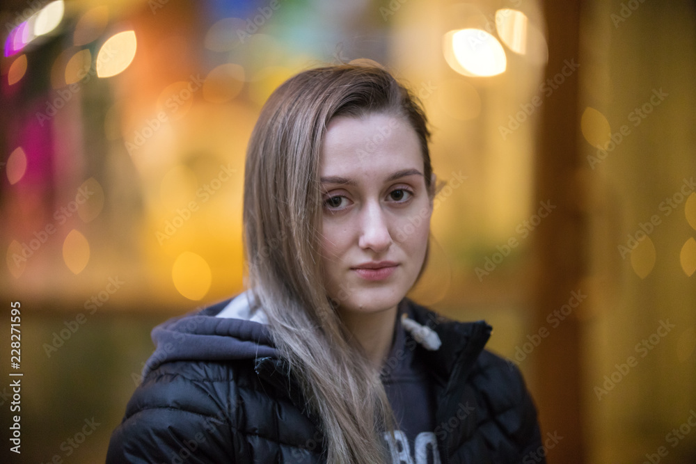 Outdoor fashion photo of beautiful young woman in black jacket looking to the camera Outdoor fashion photo of beautiful young woman in black jacket looking to the camera