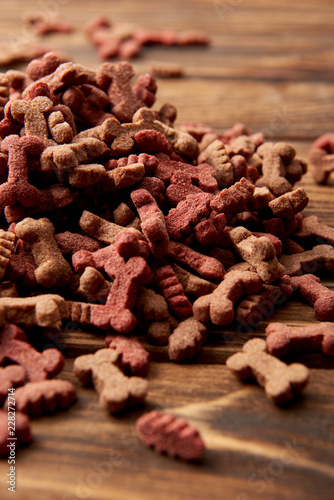 selective focus of pile of dog food on wooden table