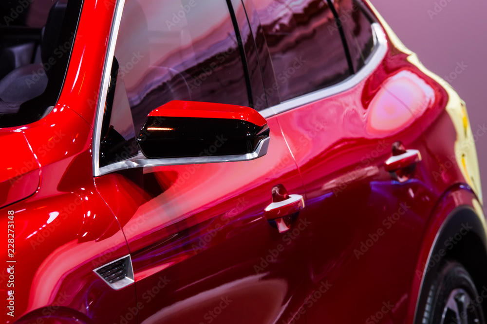 Closeup high-detailed view on rearview mirror of red car
