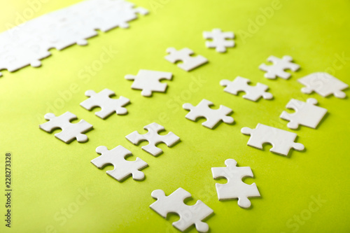 Incomplete jigsaw puzzle on color background © Pixel-Shot