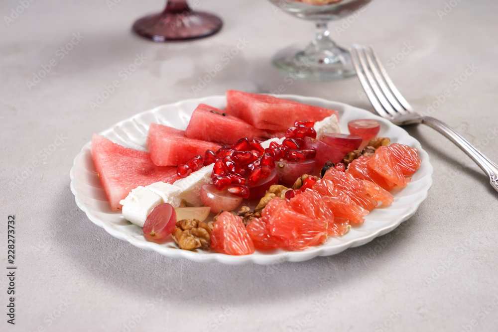 Plate with delicious watermelon salad on table Plate with delicious watermelon salad on table
