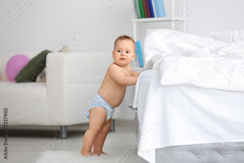 Cute little baby standing n...