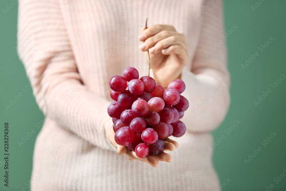 Woman holding ripe juicy grapes, closeup