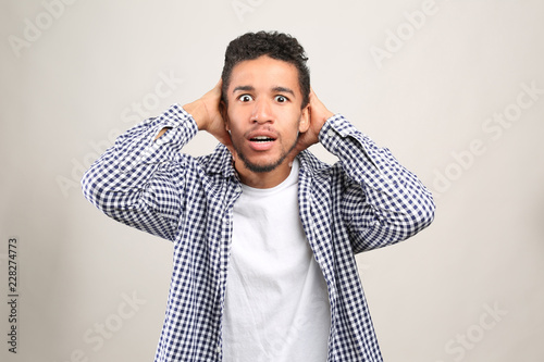 Portrait of scared African-...