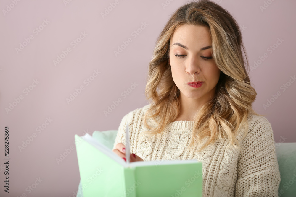 Portrait of beautiful young woman reading book at home Portrait of beautiful young woman reading book at home