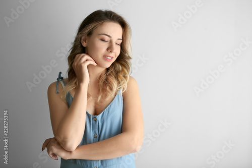 Portrait of beautiful young woman on light background