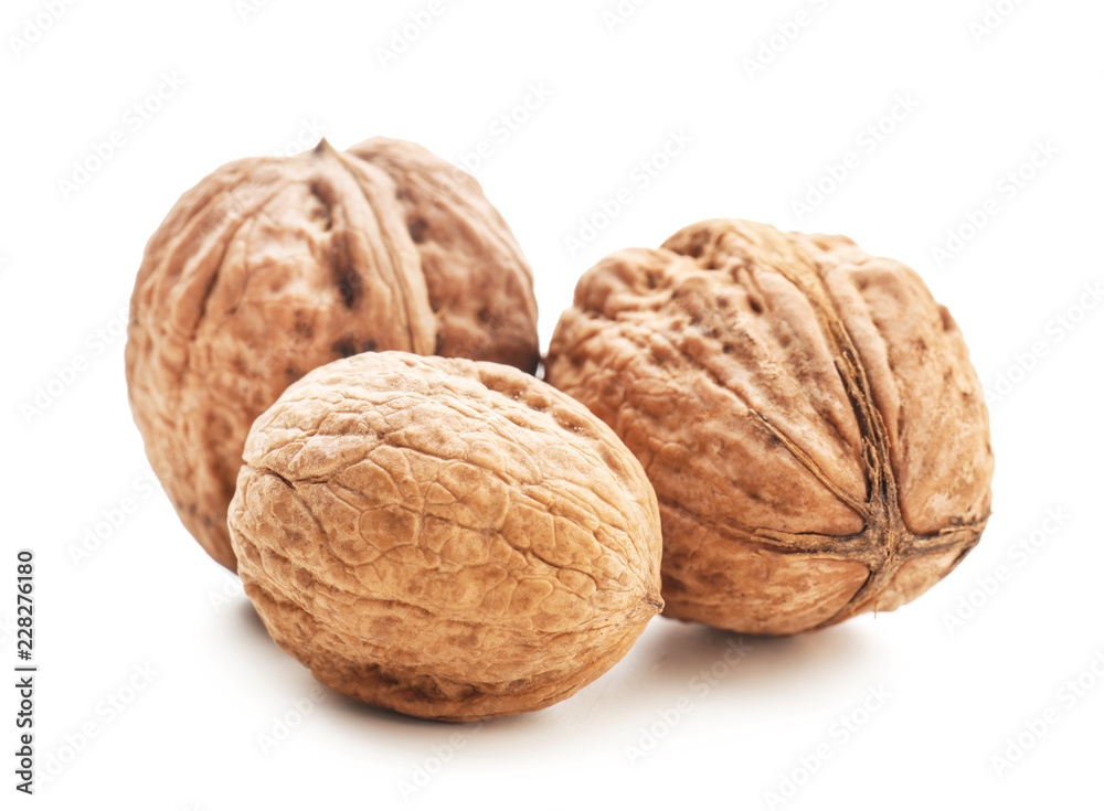 Unpeeled walnuts on white background Unpeeled walnuts on white background