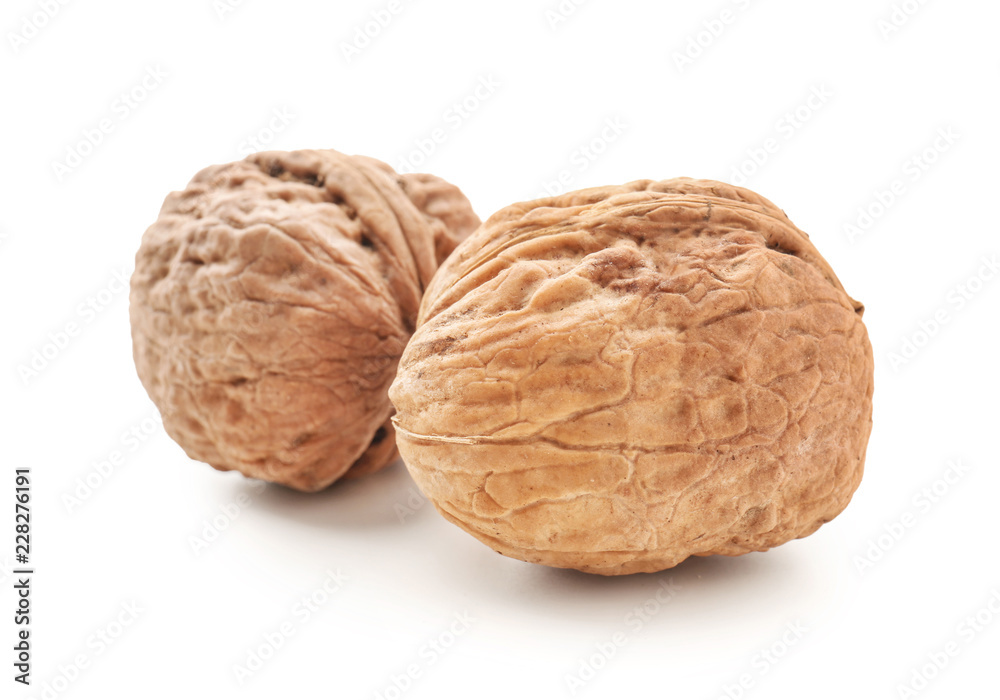 Unpeeled walnuts on white background Unpeeled walnuts on white background