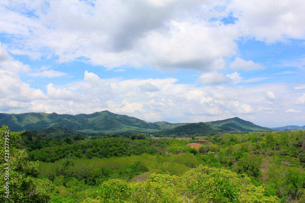 Blue sky with clouds and green hills at Ban Bung Sam Phan Nok, Phetchabun, Thailand.