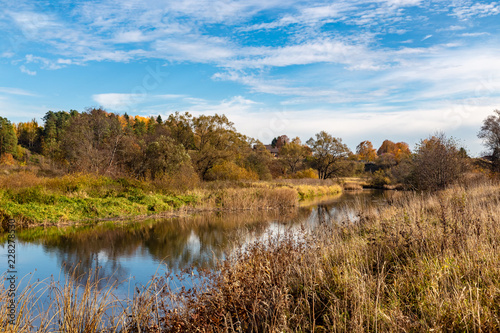 Autumn landscape. View of the river and autumn forest