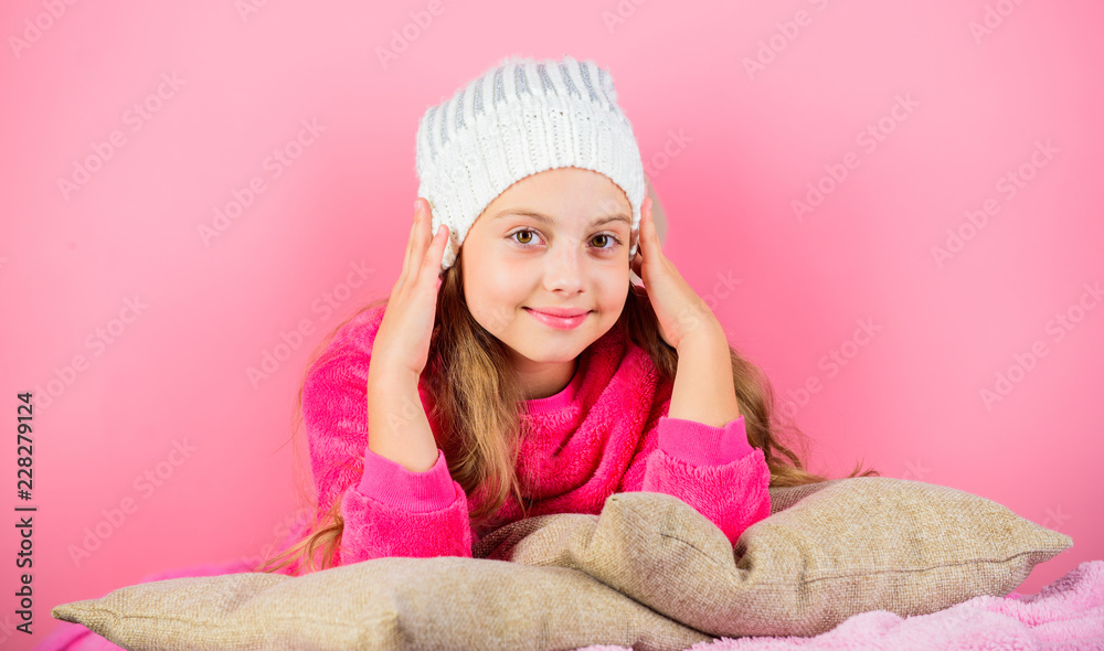 Kid dreamy lean on pillows. Winter season coziness attribute. Winter season concept. Winter fashion accessory. Winter accessory concept. Girl long hair dream pink background. Kid girl knitted hat Kid dreamy lean on pillows. Winter season coziness attribute. Winter season concept. Winter fashion accessory. Winter accessory concept. Girl long hair dream pink background. Kid girl knitted hat