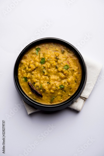 Dal Tadka Fry / Indian Lentil Curry served in a bowl with rice and roti, selective focus