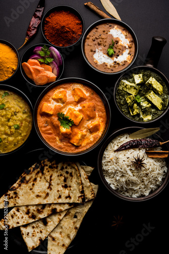 Indian Lunch / Dinner main course food in group includes Paneer Butter Masala, Dal Makhani, Palak Paneer, Roti, Rice etc, Selective focus