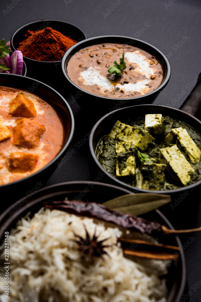 Indian Lunch / Dinner main course food in group includes Paneer Butter Masala, Dal Makhani, Palak Paneer, Roti, Rice etc, Selective focus Indian Lunch / Dinner main course food in group includes Paneer Butter Masala, Dal Makhani, Palak Paneer, Roti, Rice etc, Selective focus
