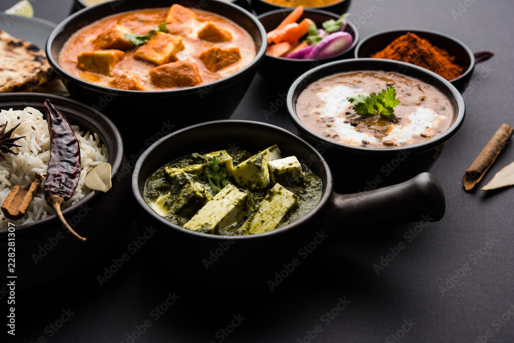 Indian Lunch / Dinner main course food in group includes Paneer Butter Masala, Dal Makhani, Palak Paneer, Roti, Rice etc, Selective focus Indian Lunch / Dinner main course food in group includes Paneer Butter Masala, Dal Makhani, Palak Paneer, Roti, Rice etc, Selective focus