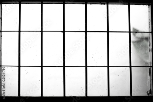 Black and white old window with iron bar