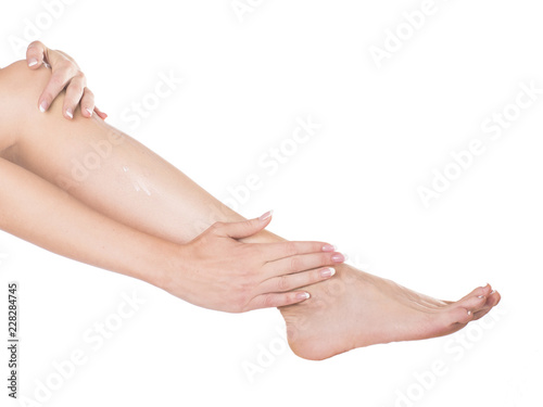 to apply foot cream it is removed in studio isolate on a white background.