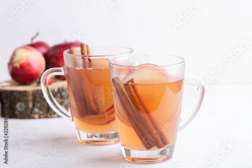 Hot cozy autumn and winter mulled cider drinks with apple slices
