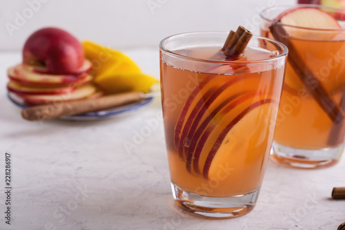 Hot cozy autumn and winter mulled cider drinks with apple slices