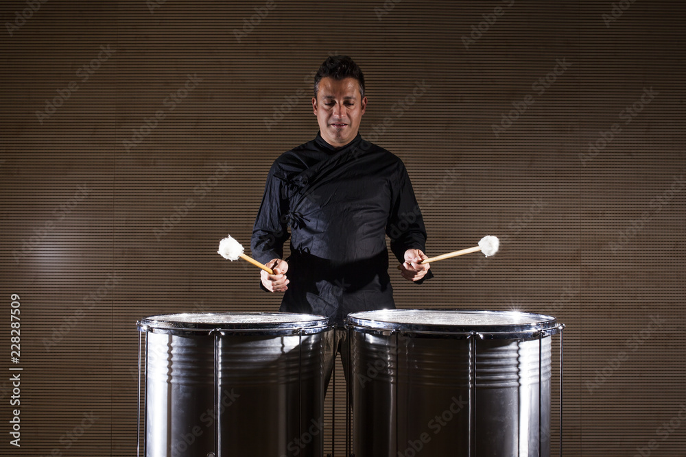 Photography percussionist practicing with two drums