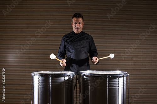 Fototapeta percussionist practicing with two drums