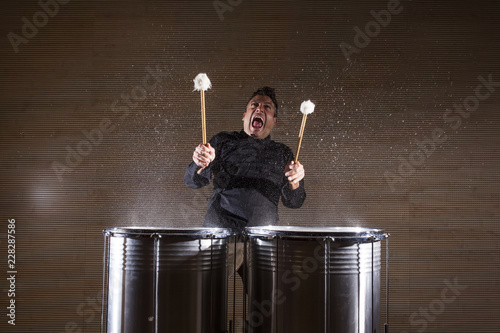 percussionist practicing with two drums photo