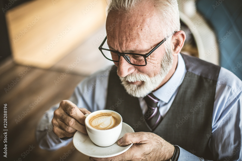 Starting his business day with a coffee. Starting his business day with a coffee.