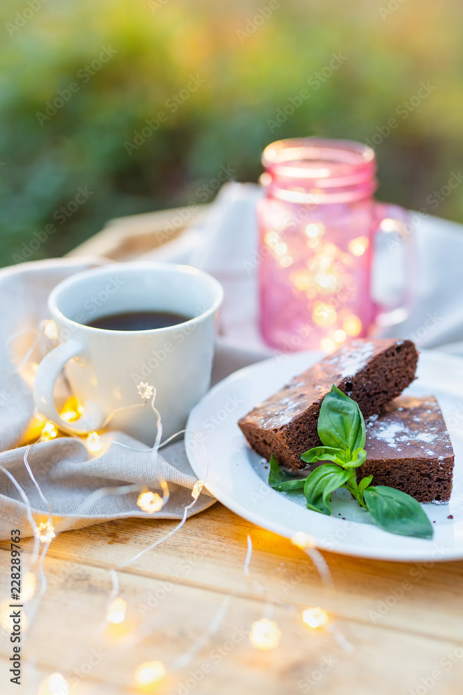 Close-up of coffee table served with coffee, tasty brownie cake