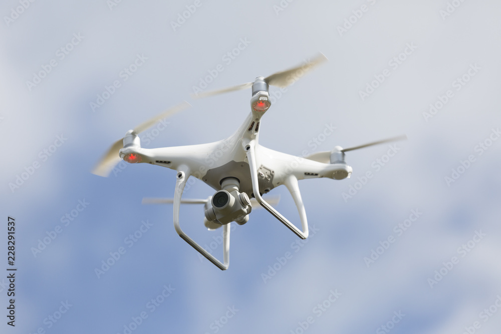 Drone quad copter with high resolution digital camera on blue sky Drone quad copter with high resolution digital camera on blue sky