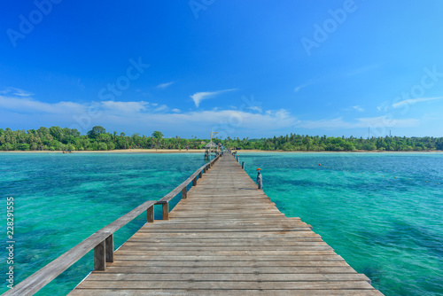 Long wooden bridge go to island on the sea in beautiful tropical island, Thailand..