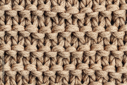 The texture of a brown knitted yarn. Knitted and winter clothes