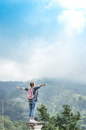 Young woman tourist in abandoned hotel on the north of Bali island, Indonesia.