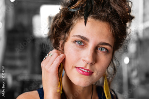 Stylish accessories. Stylish modern dark-haired blue-eyed woman with piercing in her nose wearing stylish accessories