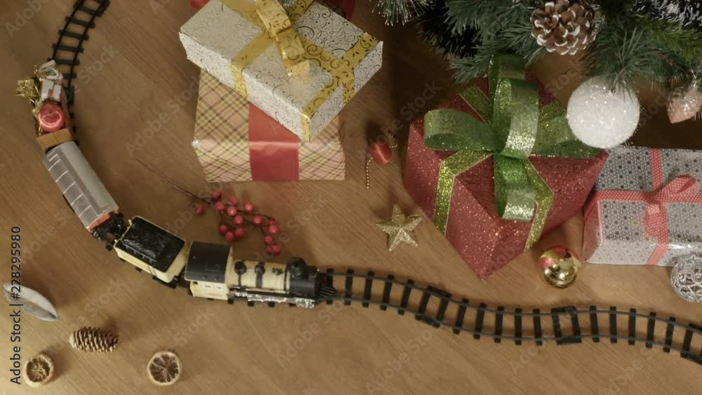 A beautiful toy steam train on the floor. 
Top view. Christmas – New Year Gift