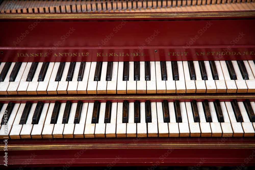 Red harpsichord in a church in Seville Spain