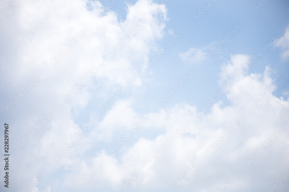 Obraz premium Bright blue sky background with white clouds.
